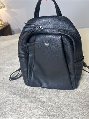 Black Pebbled Leather Daypack Backpack with Subtle Metal Emblem